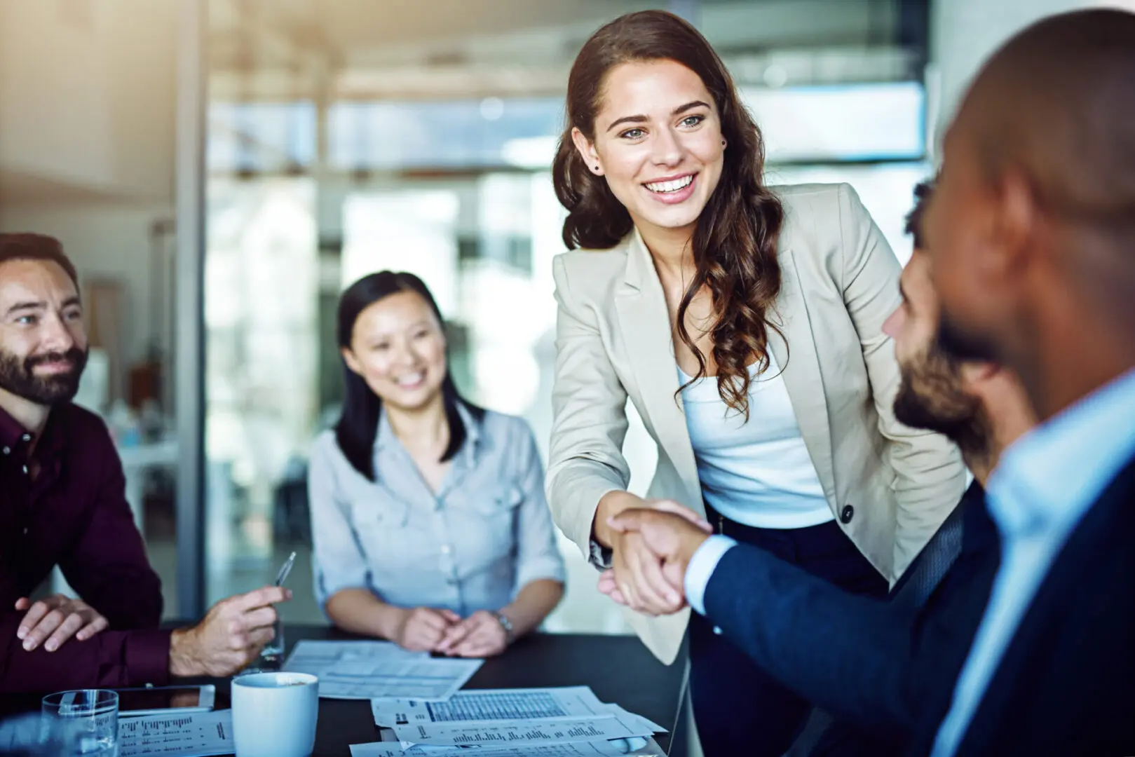 Cropped shot of two businesspeople shaking hands during a meeting in the boardroom